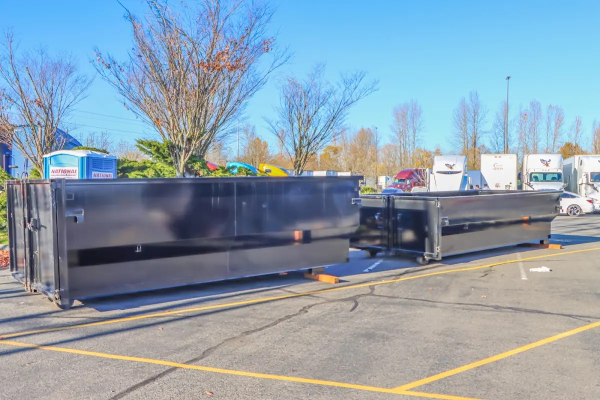 Professional dumpster rental service with roll-off container on residential driveway in Collierville